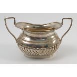 A silver two handled sugar bowl, of oval form with gadrooned edge and lower body, Chester 1903,
