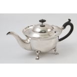 A silver tea pot, of circular form, raised on paw feet, London 1904, maker Hutton & Sons Ltd,