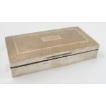 A silver cigarette box, of rectangular form, with engine turning,