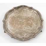 A silver salver, the ogee edge with ribbed decoration and swags, bearing inscription to the centre,