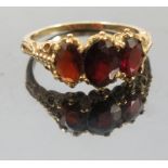 A three stone garnet 9ct gold ring, in the Victorian style, finger size U, weight 4.