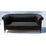 A 19th century Chesterfield, raised on short tapering turned legs,