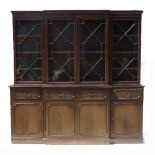 A Georgian design mahogany break front bookcase, having astragal glazed doors to the top,