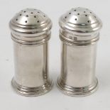 A pair of boxed silver pepper pots, of cylindrical form,