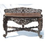 A Burmese style hardwood side table, of serpentine outline, raised on cabriole legs united by