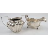 A group of hallmarked silver, to include a sauce boat with bead edge, a tea strainer and stand,