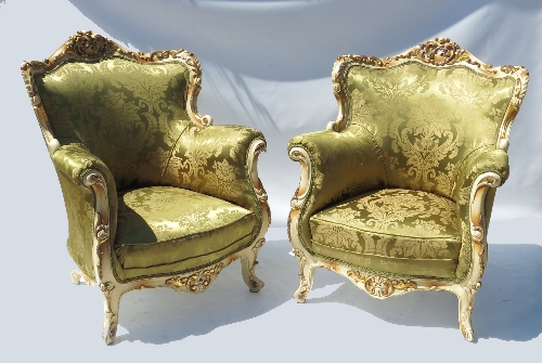 A pair of ornate gilt and painted Duchess style salon chairs,