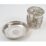 An African white metal circular covered pot, the lid embossed with lions,