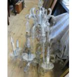 An early 20th century eight branch glass chandelier, having scrolling arms and lustres,