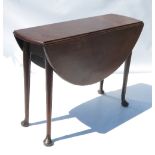 A Georgian mahogany oval gate leg table, raised on turned legs terminating in pad feet,