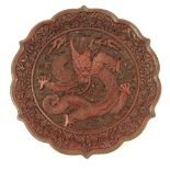 A Chinese cinnabar lacquer plate, decorated with a dragon, to a flower border with shaped edge,