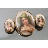 A bar brooch, formed with an oval porcelain plaque flanked by two smaller oval porcelain plaques,