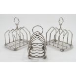 A pair of five bar silver toast racks, with angular bars and raised on oblate bun feet,