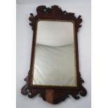 A 19th century mahogany fret cut wall mirror, decorated with leaves,