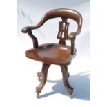 A late 19th century swivel open armchair