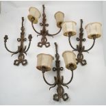 A set of four GEC gilt metal two light wall lights, with ribbon and tassel decoration,