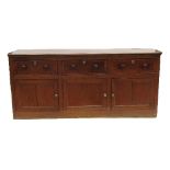 A 19th century oak cupboard dresser, having three cross banded drawers over three cupboard doors,