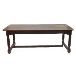 An oak rectangular dining table, having four plank cleated top,