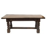 A reproduction oak refectory table, of rectangular form, with carved side frieze,