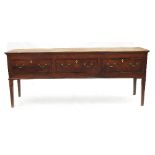 A 19th century oak dresser base, fitted three drawers to the frieze,