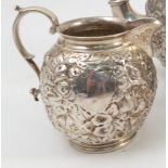 A Victorian silver teapot, with embossed floral decoration and vacant cartouche,