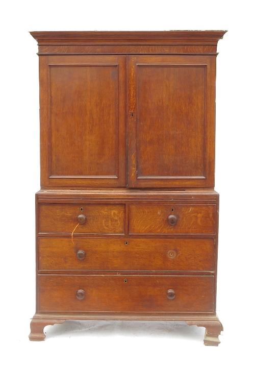 A 19th century oak linen press, having two panelled doors to the upper section,