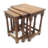 A nest of three rectangular oak tables, raised on turned legs, united by stretchers, width 20.