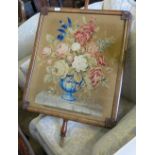 A 19th century mahogany pole screen, the rectangular screen with embroidery of flowers,