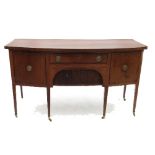 A 19th century mahogany bow front sideboard, the central drawer with tambour cupboard below,