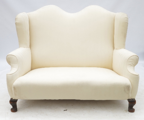 A Georgian design camel back sofa, raised on short cabriole legs,