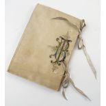 An early 20th century Italian vellum covered note book, with leather ties,