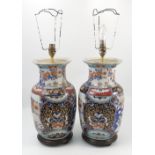 A pair of Imari vases, converted to lamp bases, of baluster form decorated with flowers,