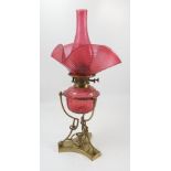 A W H Honey oil lamp, having a cranberry glass chimney,