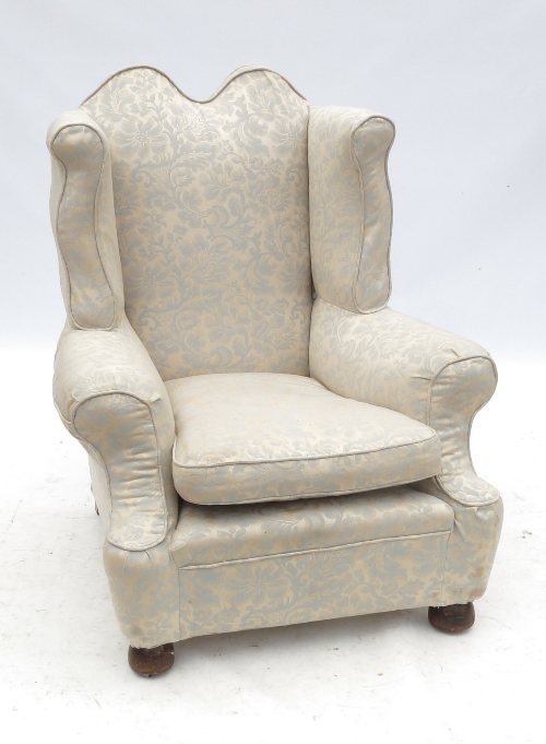 A Georgian design fireside wing armchair