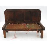 A rustic oak settle, having four panels to the back,