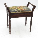 A 19th century mahogany piano stool, with turned carrying handles to each end,