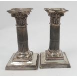 A pair of Victorian silver candlesticks, of corinthian column form with acanthus decoration,