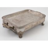 A rectangular silver plated warming dish, engraved with a coat of arms,