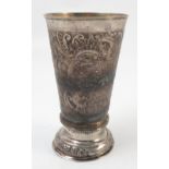 A white metal beaker, embossed with scrolls, foliage and animals of trumpet shaped form height 6.