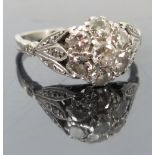 A seven stone diamond cluster ring, stamped 'Plat',