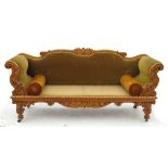 A pale mahogany double end sofa, with carved scrolling acanthus frame,