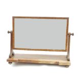 A 19th century mahogany rectangular swing frame toilet mirror, with inverted break front base,