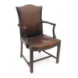 A leather upholstered armchair,