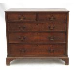 A Georgian oak chest of drawers, fitted two short cross banded drawers over three long drawers,