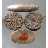 A filigree brooch, together with another similar with a stone to the centre,