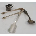 A pair of Georgian silver sugar tongs, a preserve spoon,