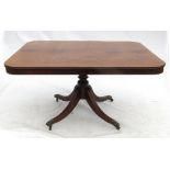 A late Georgian mahogany breakfast table, with rounded corners and a cross banded top,