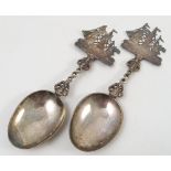 Two white metal spoons, with pierced stem and pierced galleon finials,