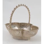A Victorian shaped silver basket, decorated to the exterior embossed leaves and scrolls,