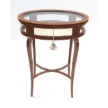 An Edwardian oval mahogany bijouterie table, with line inlay,